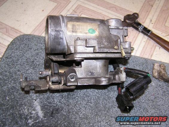 Back side of TBI / Throttle intake manifold. Notice the throttle/idle adjust screw, it was hidden behind a cap. I had to un-screw it about 1 full turn to get the idle down from 1300 RPM to 1000 RPM