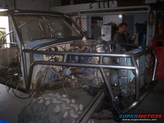 Toyota 4Runner with custom roll cage, front view, showing engine and radiator