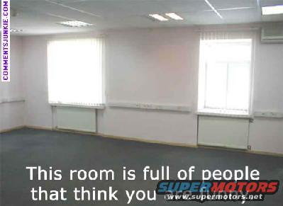Empty office room with two windows and radiators. Text overlay says 'This room is full of people that think you'