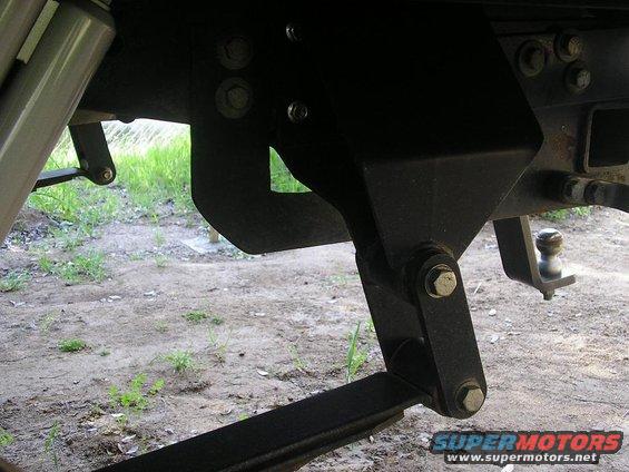 Rear suspension and hitch assembly with leaf springs and shock absorber