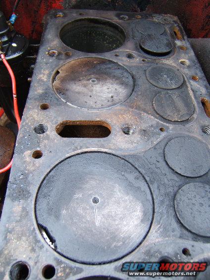 Engine cylinder head with valves and bolt holes