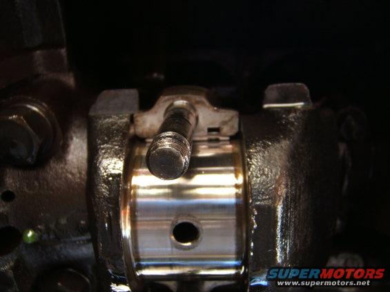 Close-up of a metal engine component with a bolt protruding