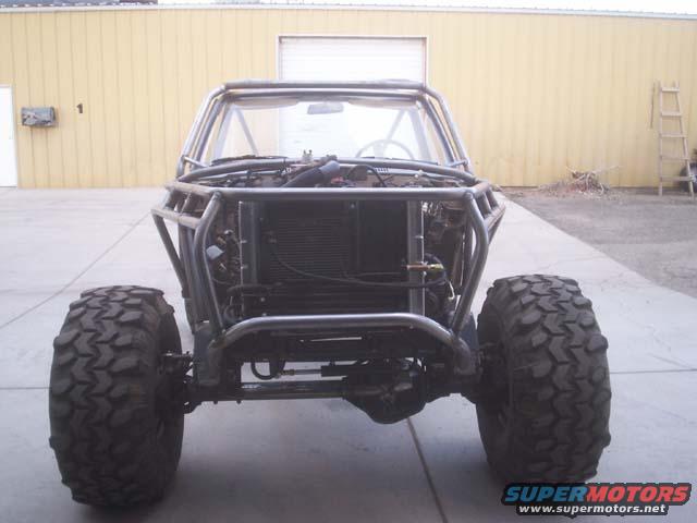 front view of a custom off-road buggy with a roll cage and large tires