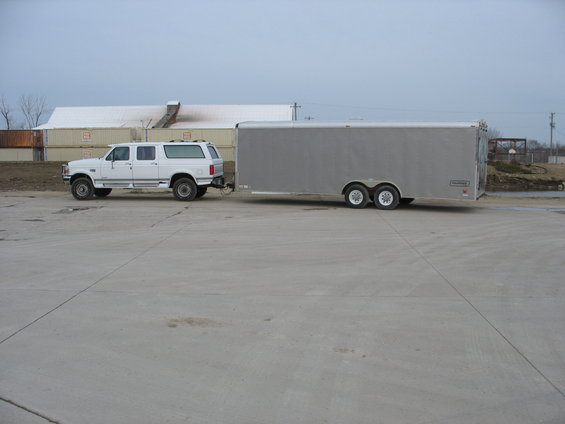 1995 Ford C-350 (Centurion Conversions) SUV towing a silver tandem-axle trailer