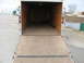 1995 Ford C-350 (Centurion Conversions) - The interior of an empty cargo trailer is shown with its rear ramp lowered.