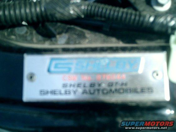 Metal identification plate with Shelby Automobiles logo and text: CSN NO. 07SGH28, SHELBY GT-H, SHELBY AUTOMOBILES