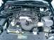 2006 Ford Mustang - The engine bay of a Ford Mustang features a V8 engine and an aftermarket cold air intake system.