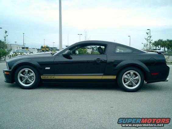 Black Ford Mustang Shelby GT-H side view with gold stripe