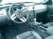 2006 Ford Mustang - The interior of a Ford Mustang, a leather steering wheel and dashboard controls.
