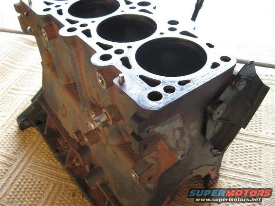 Rusty engine block with cylinder bores visible