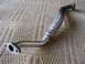 1999 Audi A4 - A metal exhaust flex pipe with braided steel and two mounting flanges is shown against a patterned background.