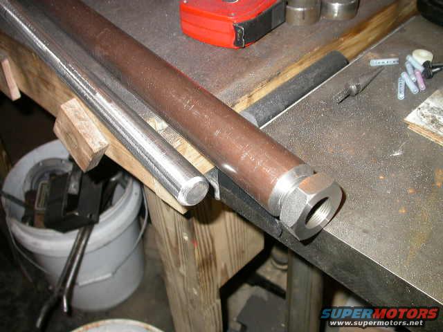 dscn6192.jpg Having seen way too many bent tie rods I wanted to do something to beef mine up.  My tie rod is already hitting the diff cover as is, so sleeving it on the outside was out.  Instead I got a section of 1" round stock to go inside of the tie rod.  It turns out that a 1" OD rod is just a bit too large to slide into a 1" ID tube, so I spent a few minutes with a sander making it just a bit smaller.  I made it a slight interference fit. 