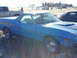 1972 Ford Ranchero - A blue coupe utility vehicle is parked outdoors next to a pickup truck and another car.