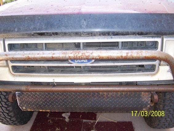 1991 Ford Bronco front grille with Ford logo, custom diamond plate bumper, and brush guard