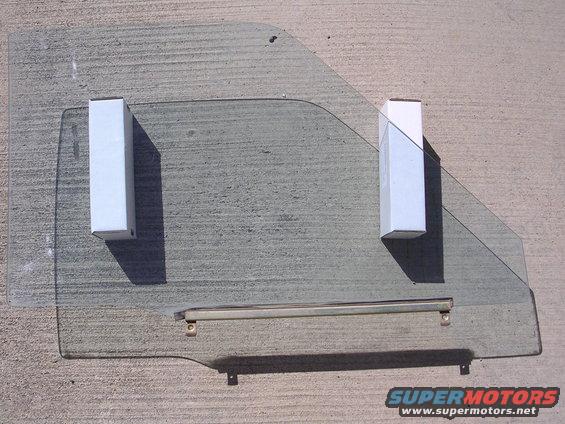 Car door window glass with two white mounting blocks