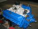 1979 Ford F-150 - A blue Ford V8 engine with a chrome air cleaner and carburetor is displayed.