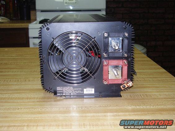 Rear view of a black power inverter with a large cooling fan and red and black battery terminals