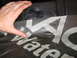 1978 Ford Bronco - Close-up of waterproofing material with text, held by a hand.