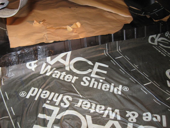 Black waterproofing membrane with white text 'ACE & Water Shield'