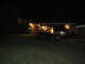 1978 Ford Bronco - Two vans are parked in a driveway at night, with one vehicle's rear hatch open.