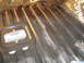 1978 Ford Bronco - The ribbed floor pan of a vehicle shows signs of sound deadening material installation.