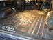 1978 Ford Bronco - The floor of a vehicle is covered with insulation material, revealing the dashboard and exposed wiring.