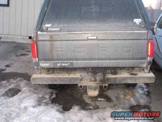 Rear of a 1990 Ford F-250 with a camper shell and a 'got Jesus?' sticker