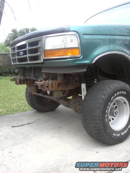 Green 1996 Ford Bronco front end, missing bumper, with chrome grille and amber turn signals