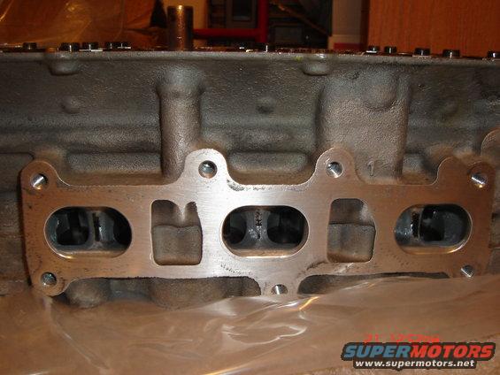 Engine cylinder head with intake manifold gasket showing four ports