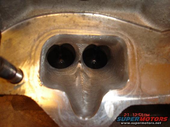 Cylinder head with two intake ports visible, metal casting, some wear