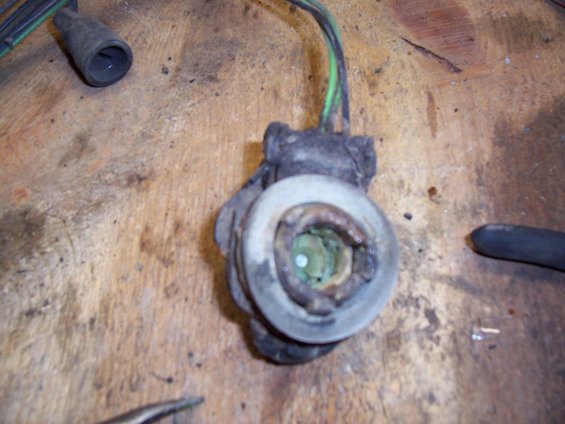 Close-up of a corroded electrical connector with green and black wires