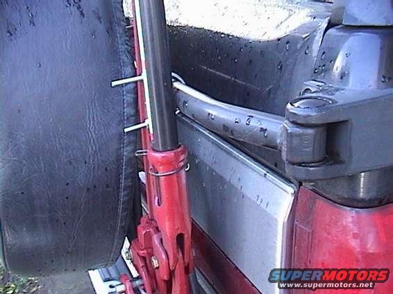 Hi-Lift jack attached to the side of a vehicle, near the spare tire