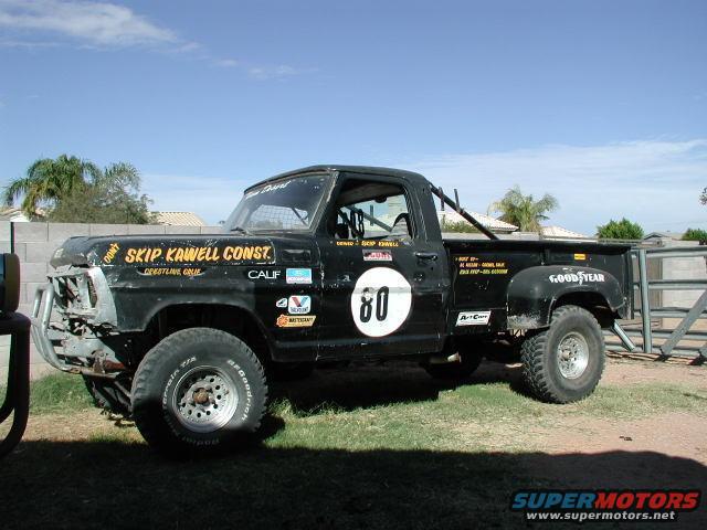 Black pickup truck with racing number 80 and 'Skip Kawell Const.' text on the door