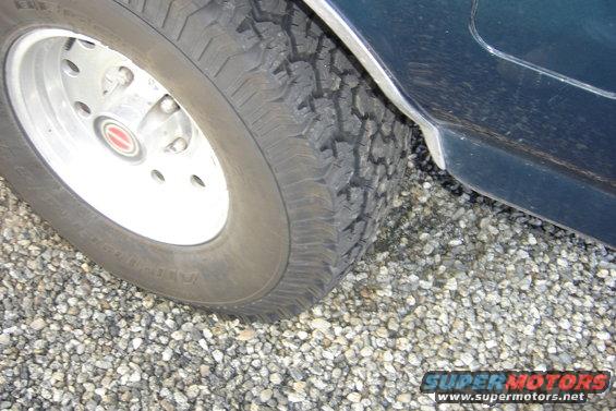 1993 Ford Bronco wheel and dark green fender close-up
