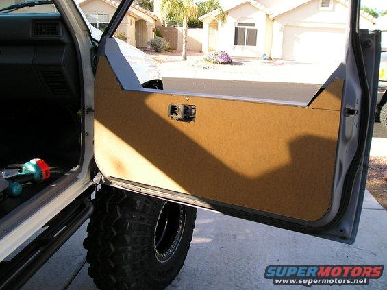Interior door panel and large off-road tire of a vehicle