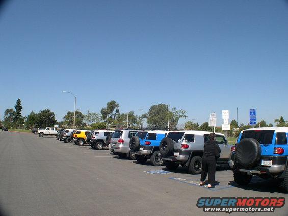 Silver and blue 2007 Toyota FJ Cruisers parked in a lot, rear view