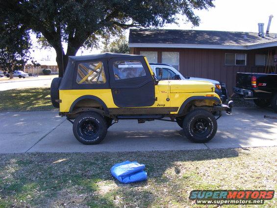 Yellow 1981 Jeep CJ7 side view with black soft top and doors