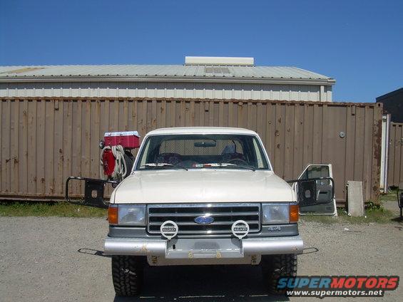 White 1991 Ford Bronco front view with aftermarket bumper and driving lights