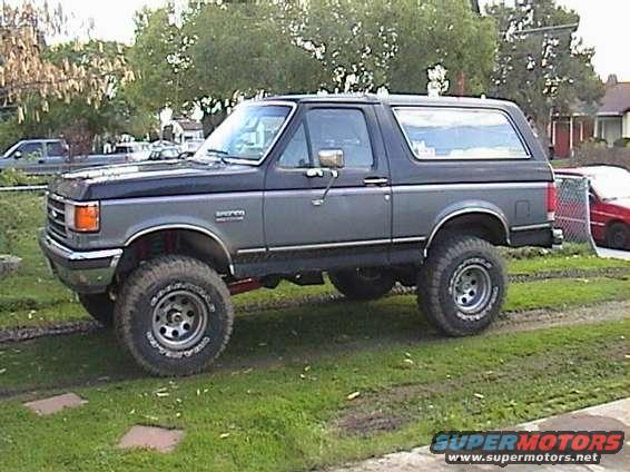 Lifted Ford Bronco, two-tone gray and black, with large off-road tires