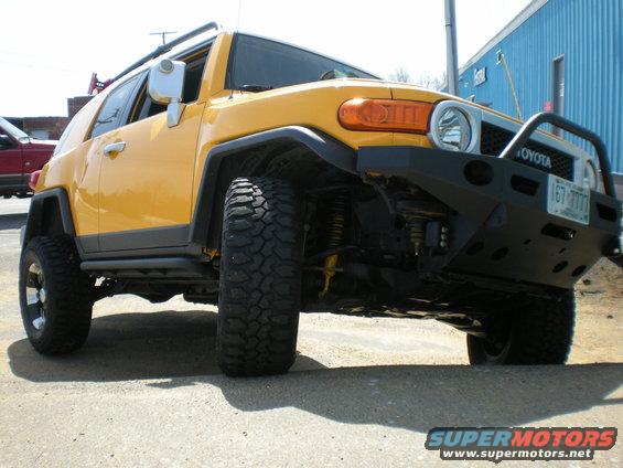 Yellow 2007 Toyota FJ Cruiser with aftermarket bumper and large tires