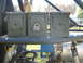 1992 Ford Mustang - Three olive drab ammo cans are secured to a metal rack, with one of them locked.