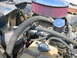 1992 Ford Mustang - Close-up of an engine bay showing an aftermarket air intake system and various hoses.