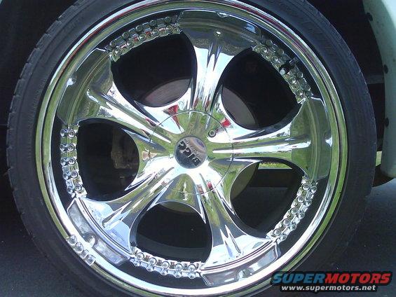 Chrome wheel with a 'BIGC' logo in the center and decorative studs around the rim