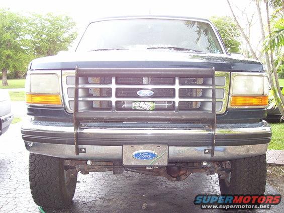 Dark green Ford Bronco front view with a black bull bar and a Ford emblem on the grille