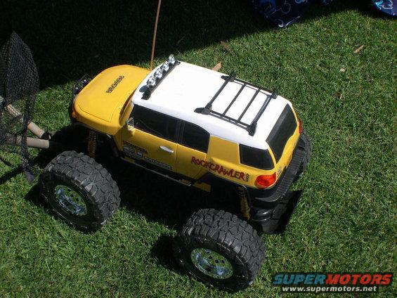 Yellow and white remote control rock crawler toy with large tires and roof rack