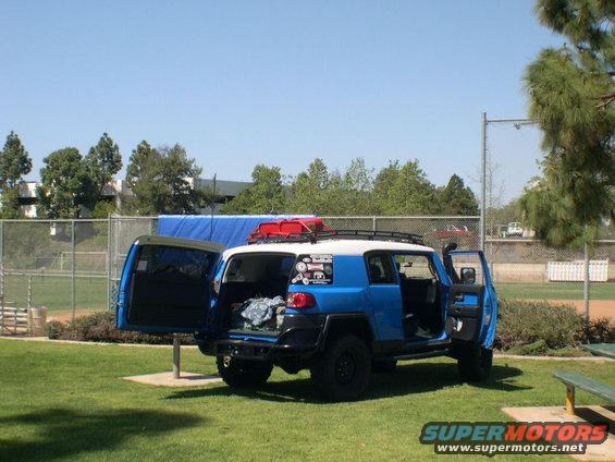Blue 2007 Toyota FJ Cruiser with open doors and roof rack