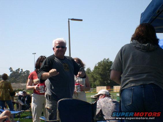 Outdoor gathering with people holding drinks