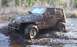 2004 Jeep TJ - This Jeep Wrangler is navigating a muddy off-road trail.