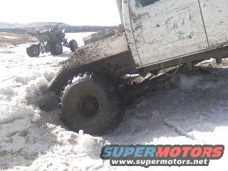 Truck stuck in snow, another vehicle in background