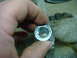 1996 Ford Bronco - A close-up view of a metal component with a damaged bolt, being handled by a person.